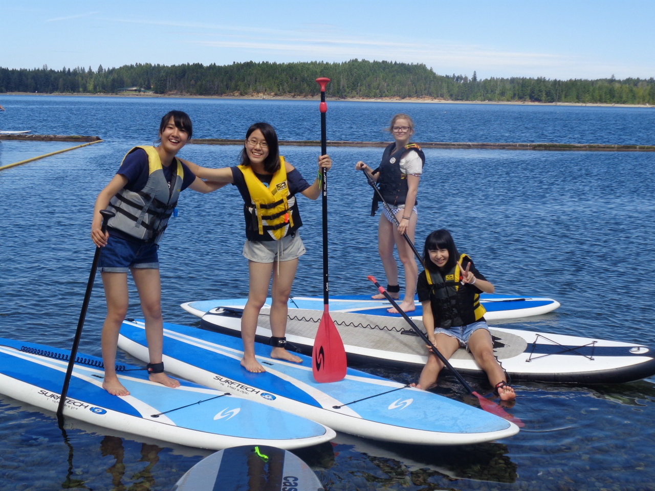 Students on paddle boards on water